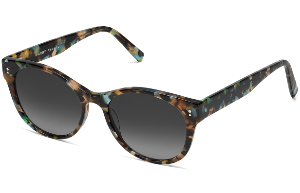 Colorful tortoiseshell patterned sunglasses with dark gradient lenses.