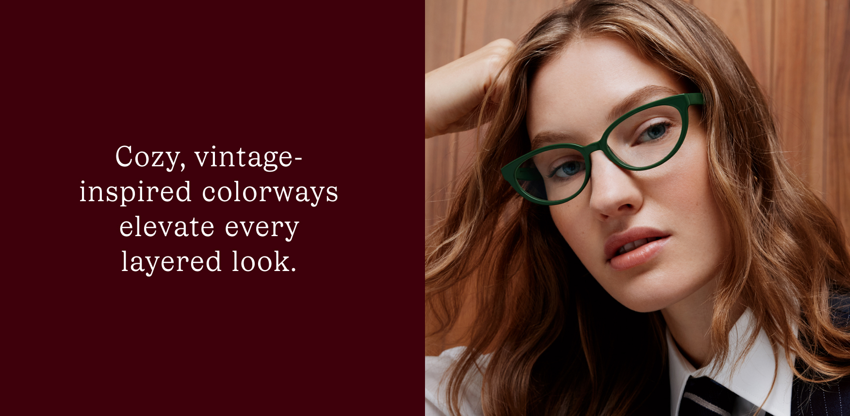 A woman wears green cat-eye glasses, complementing her layered outfit.