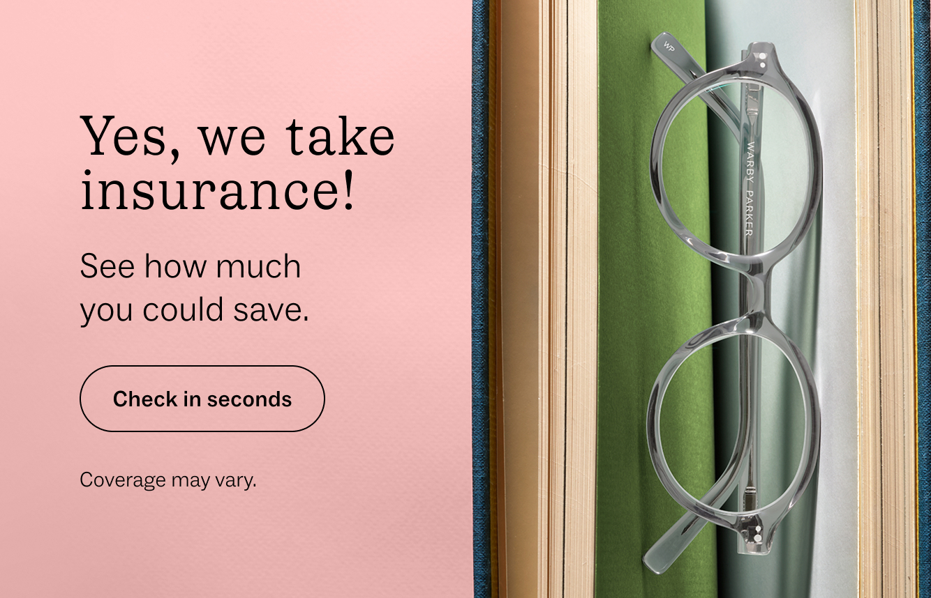 Clear glasses resting on a stack of books with text overlay "Yes, we take insurance!"