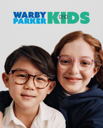 Two smiling kids wearing glasses — one in tortoiseshell frames, the other in light pink ones.