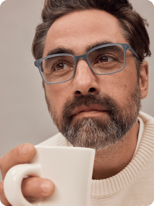 Smiling person with glasses and , white shirt.